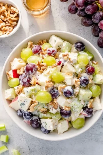 A vibrant Waldorf Salad featuring apples, walnuts, and celery served in a bowl.