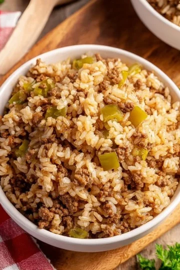 Plate of homemade Dirty Rice garnished with herbs and spices