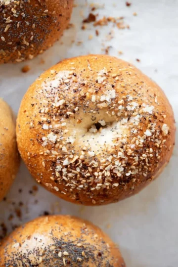 Fresh homemade bagels with sesame seeds on a wooden table